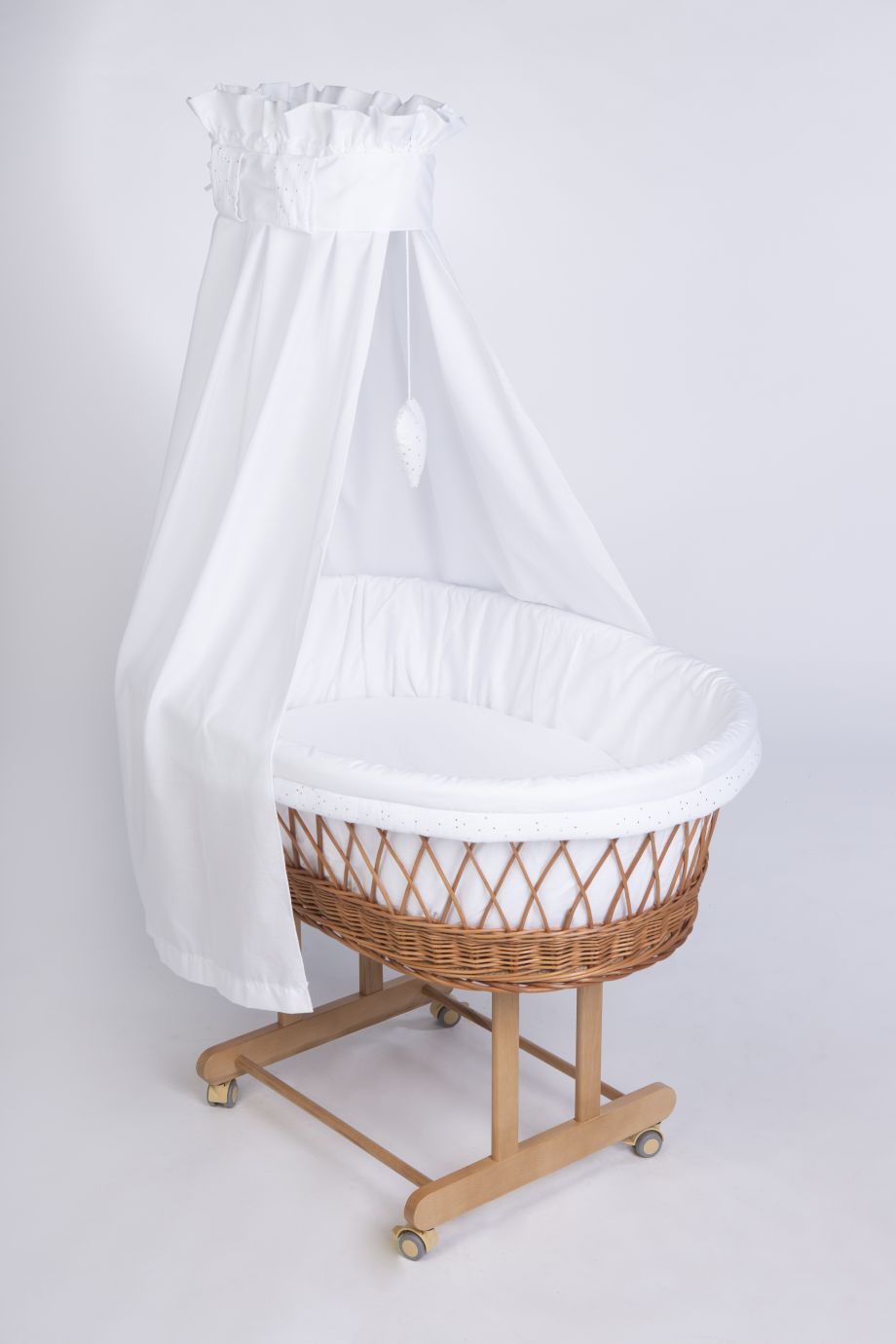 Natural wicker Stubenwagen with white fabric lining and sheer white canopy draped over wooden frame with wheels. - Mionido - Stubenwagen Maxi (natur)